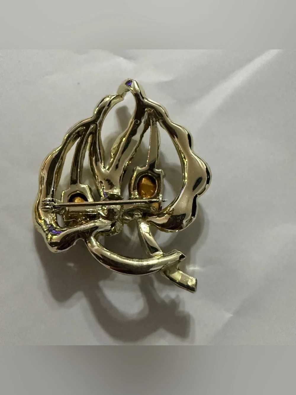 Vintage gold tone leaf brooch with red and clear rhinestones